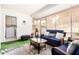 Cozy sunroom with a blue sofa, wicker furniture, and a view of the backyard at 17822 N Del Webb Blvd, Sun City, AZ 85373
