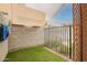 Cozy backyard space featuring artificial turf, privacy wall, and metal fencing at 18374 W Stinson Dr, Surprise, AZ 85374