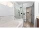 Modern bathroom featuring a glass-enclosed shower, soaking tub, and stylish tile work at 18374 W Stinson Dr, Surprise, AZ 85374
