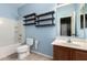 Bright bathroom features a shower-tub combo, stylish wood shelving, and a modern vanity at 18374 W Stinson Dr, Surprise, AZ 85374