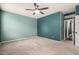 Large bedroom featuring two-tone green walls, carpet flooring and a ceiling fan at 18374 W Stinson Dr, Surprise, AZ 85374