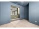 Bedroom featuring gray carpet flooring and a view through the doorway of the adjacent room at 18374 W Stinson Dr, Surprise, AZ 85374