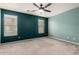 A spacious bedroom is adorned with two windows and a ceiling fan for optimal comfort at 18374 W Stinson Dr, Surprise, AZ 85374