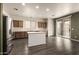 Open-concept kitchen with an island, stainless steel appliances, and a sliding glass door to the backyard at 18374 W Stinson Dr, Surprise, AZ 85374