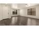 Bright living room with laminate flooring and natural light from multiple windows at 18374 W Stinson Dr, Surprise, AZ 85374