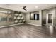 Living room featuring stylish accent wall, modern ceiling fan, and an open layout at 18374 W Stinson Dr, Surprise, AZ 85374
