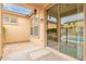 Covered patio with tile flooring, offering seamless transition to a sparkling pool at 18374 W Stinson Dr, Surprise, AZ 85374