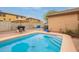 Outdoor pool area with clear water, patio, and barbecue grill for entertaining guests at 18374 W Stinson Dr, Surprise, AZ 85374