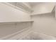 Walk-in Closet featuring white walls and clothing racks on three sides at 18374 W Stinson Dr, Surprise, AZ 85374