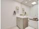 Stylish bathroom with a gray vanity, decorative artwork, and contemporary fixtures at 18607 N 125Th Ave, Sun City West, AZ 85375