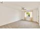 Spacious bedroom featuring a ceiling fan, plush carpet, and ample natural light at 18607 N 125Th Ave, Sun City West, AZ 85375