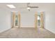 Bright bedroom with plush carpet, a modern ceiling fan, and dual windows at 18607 N 125Th Ave, Sun City West, AZ 85375
