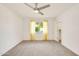 A light-filled bedroom with neutral carpet, ceiling fan, and natural light at 18607 N 125Th Ave, Sun City West, AZ 85375