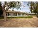Well-maintained home showcasing a screened-in porch and meticulously landscaped yard with desert landscaping and mature trees at 18607 N 125Th Ave, Sun City West, AZ 85375