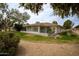 Attractive home showcasing a screened-in porch, desert landscaping, and lush green grass providing a peaceful and inviting atmosphere at 18607 N 125Th Ave, Sun City West, AZ 85375