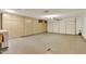 Spacious garage with ample built-in storage cabinets and large overhead door at 18607 N 125Th Ave, Sun City West, AZ 85375