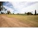 Expansive golf course view featuring lush green fairways, mature trees, and blue skies, promising a serene recreational environment at 18607 N 125Th Ave, Sun City West, AZ 85375