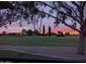 Scenic golf course view at sunset, framed by trees, offering a tranquil and picturesque setting at 18607 N 125Th Ave, Sun City West, AZ 85375