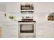Modern kitchen showing stainless steel oven, white cabinetry, and subway tile backsplash at 18607 N 125Th Ave, Sun City West, AZ 85375