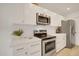 Close-up of the kitchen with stainless steel appliances, white cabinets, and light countertops at 18607 N 125Th Ave, Sun City West, AZ 85375