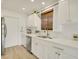 Bright kitchen features white cabinetry, stainless steel appliances, and a window with woven shades at 18607 N 125Th Ave, Sun City West, AZ 85375