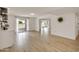 Spacious living room with light wood flooring and sliding glass doors to the outdoor patio at 18607 N 125Th Ave, Sun City West, AZ 85375