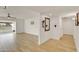 Bright and airy living room with wood-look tile flooring and views to an adjacent sun room at 18607 N 125Th Ave, Sun City West, AZ 85375
