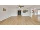 Spacious living room with wood-look tile flooring, double-door entry, and ample natural light at 18607 N 125Th Ave, Sun City West, AZ 85375