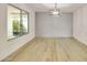 Bright living area showcasing wood-look tile flooring and large picture window at 18607 N 125Th Ave, Sun City West, AZ 85375
