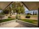 Inviting covered patio offers serene views of the golf course and mature trees, creating an ideal outdoor living space at 18607 N 125Th Ave, Sun City West, AZ 85375
