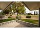 Covered patio overlooking the golf course with mature trees, providing a perfect spot for relaxation and enjoying the outdoor scenery at 18607 N 125Th Ave, Sun City West, AZ 85375