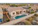 Aerial view of a home with a sparkling pool and a complete outdoor kitchen at 20289 N 259Th Ave, Buckeye, AZ 85396