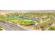 Beautiful aerial view of the community entrance with a scenic pond and lush green golf course at 20289 N 259Th Ave, Buckeye, AZ 85396