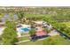 Aerial view showcasing splash pad with covered seating, a playground, and grassy playfields at 20289 N 259Th Ave, Buckeye, AZ 85396