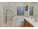 Bright bathroom featuring a separate shower and tub with tile flooring and wood cabinets at 20289 N 259Th Ave, Buckeye, AZ 85396