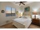 Bedroom with a bed, nightstand, and window providing natural light and a calming sunset view at 20289 N 259Th Ave, Buckeye, AZ 85396