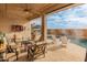 Expansive covered patio with an outdoor seating area and views of the sparkling pool and landscape at 20289 N 259Th Ave, Buckeye, AZ 85396