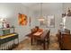 Charming dining room featuring a wood table, decorative chandelier, and stylish decor at 20289 N 259Th Ave, Buckeye, AZ 85396