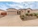 Charming single-Gathering home with a three car garage and beautiful desert landscaping on a bright day at 20289 N 259Th Ave, Buckeye, AZ 85396