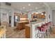 Spacious kitchen boasts wood cabinets, stainless steel appliances, an island, and counter seating at 20289 N 259Th Ave, Buckeye, AZ 85396