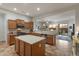 Well-lit open kitchen with stainless appliances, an island and a view of the backyard patio at 20289 N 259Th Ave, Buckeye, AZ 85396