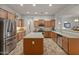 Bright kitchen with an island, stainless steel appliances, and plenty of wooden cabinet space at 20289 N 259Th Ave, Buckeye, AZ 85396