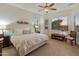 Serene main bedroom with neutral tones, a ceiling fan, and multiple windows at 20289 N 259Th Ave, Buckeye, AZ 85396