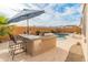 Outdoor kitchen and barbecue area, adjacent to the pool, and lounge area at 20289 N 259Th Ave, Buckeye, AZ 85396