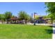 Inviting park area with shaded picnic tables, a playground, and expansive green space at 20289 N 259Th Ave, Buckeye, AZ 85396