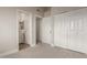 Bedroom with bi-fold closet doors and adjacent bathroom entrance at 2301 E University Dr # 393, Mesa, AZ 85213