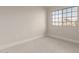 Bright bedroom with a large window and neutral carpet, ready for personalization at 2301 E University Dr # 393, Mesa, AZ 85213
