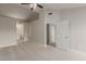 Large primary bedroom with vaulted ceiling, ensuite bathroom, and hallway at 2301 E University Dr # 393, Mesa, AZ 85213