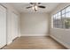 Charming bedroom with light, airy walls, hardwood floors, ceiling fan and double door closet at 2301 E University Dr # 393, Mesa, AZ 85213