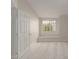 Bedroom with an open door, window, and light carpet at 2301 E University Dr # 393, Mesa, AZ 85213